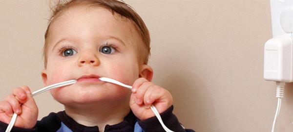 baby biting on a wire